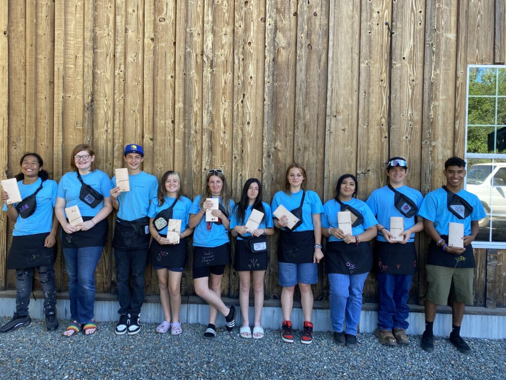 A group of students holding an envelope